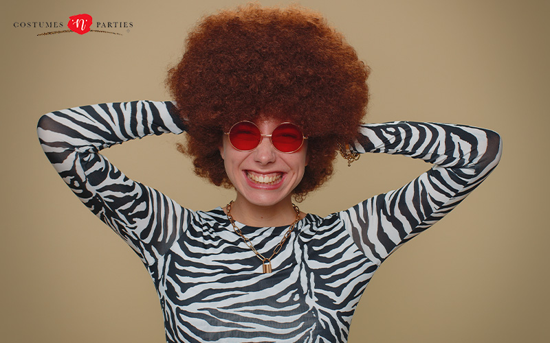Woman smiling in a 70s-themed costume.